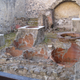 The remains of a thermopolium at Herculaneum (a nearby town that suffered a similar fate as Pompeii) show how the dolia were built into the counter first, and then the counter built around the containers.